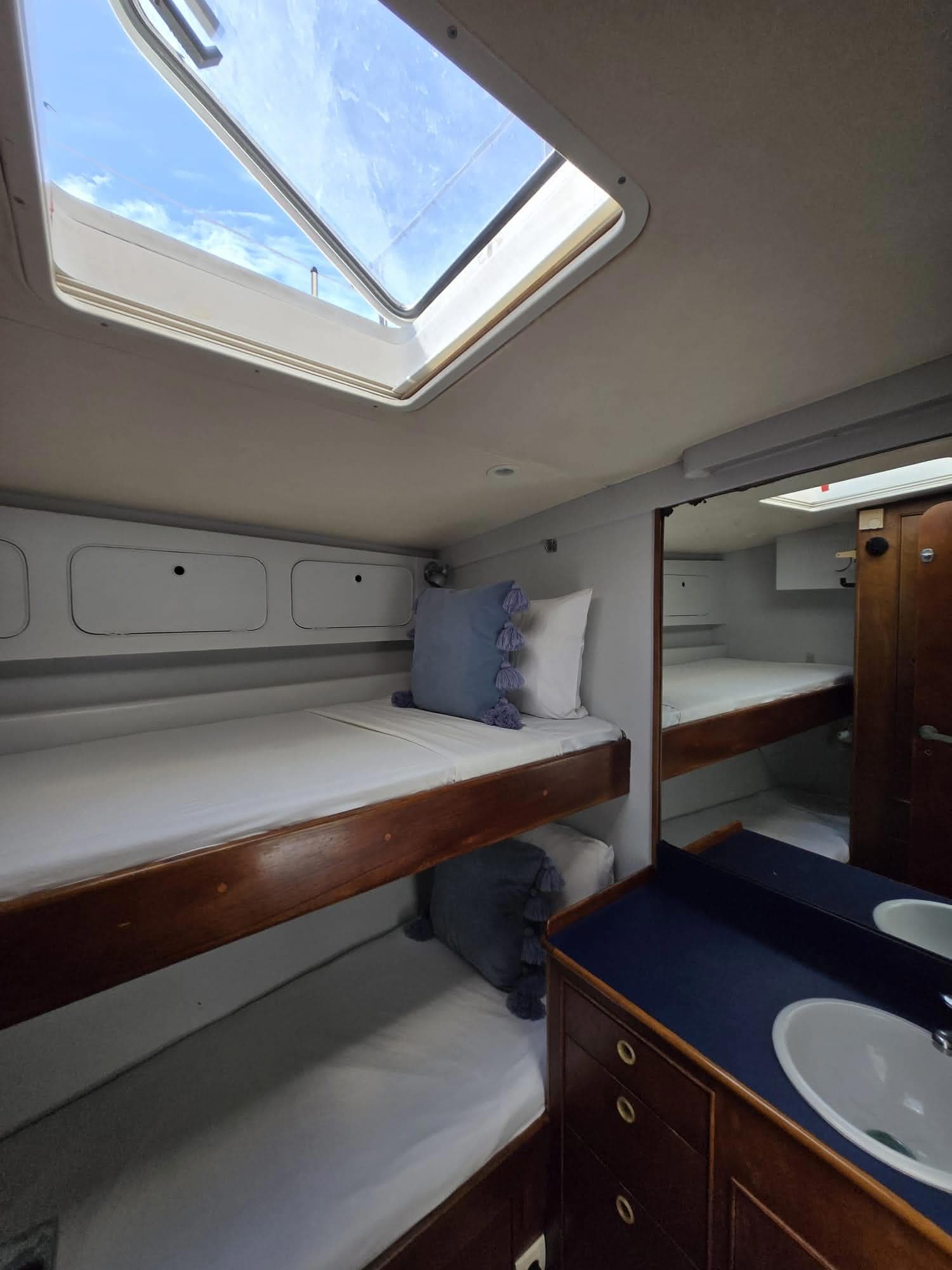 Flying Wing guest cabin with open skylight and blue sky overhead