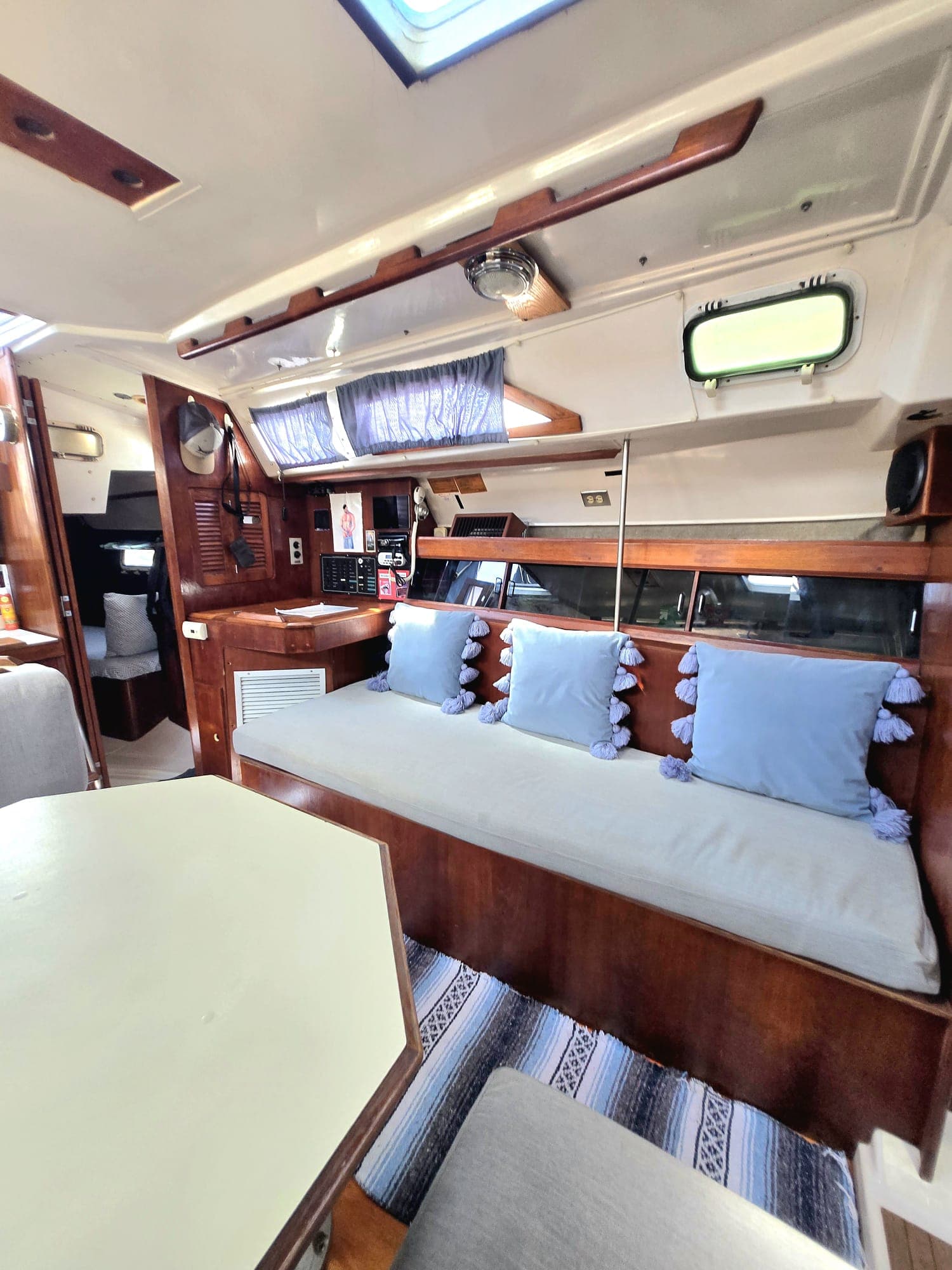 SISU salon dinette with navy tassel pillows and mahogany joinery