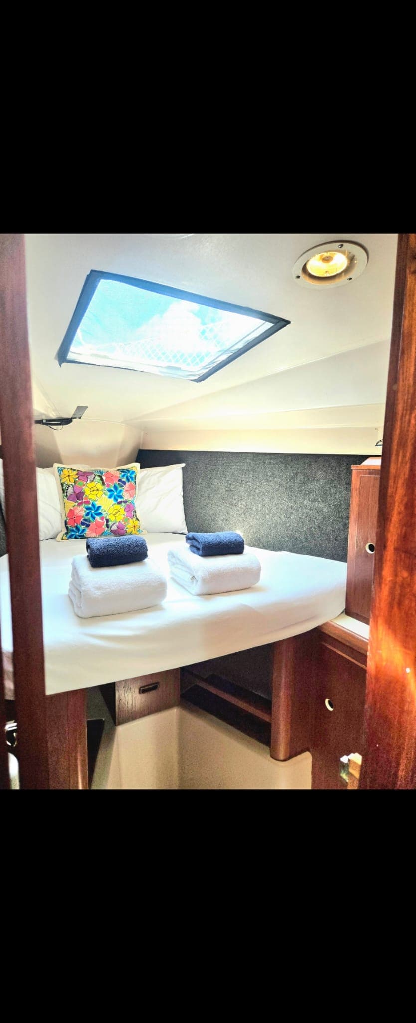 SISU forward V-berth made up with white linens and folded towels